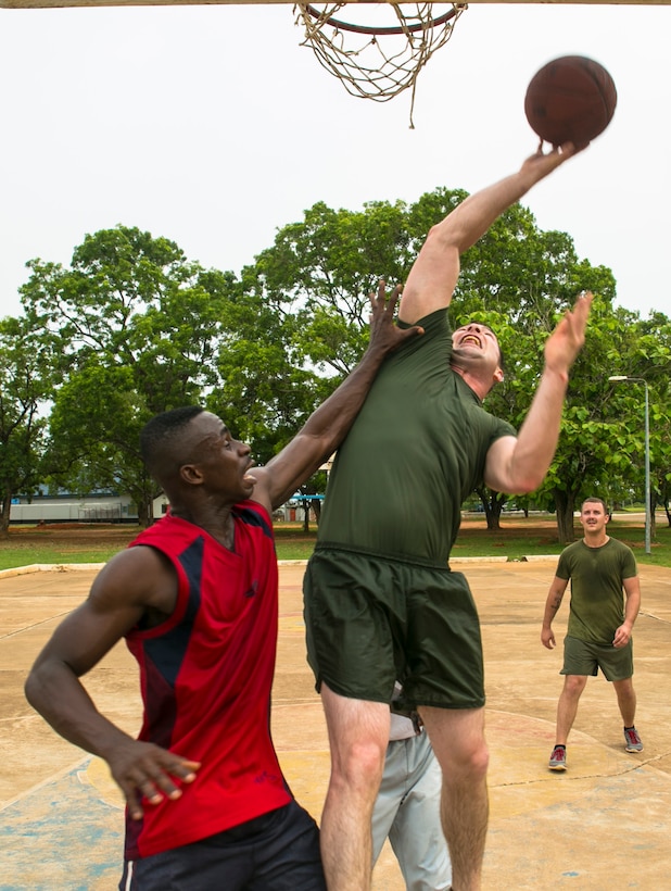 U.S. Marine Cpl. Matthew Duggan, a member of Special-Purpose Marine Air-Ground Task Force Crisis Response-Africa, attempts to score during a basketball game with Ghanaian service members in Accra, Ghana, April 2, 2015. The Marines were in Accra testing their ability to establish a Cooperative Security Location and took an afternoon off to play sports with their Ghanaian counterparts. (U.S. Marine Corps photo by Sgt. Paul Peterson/Released)