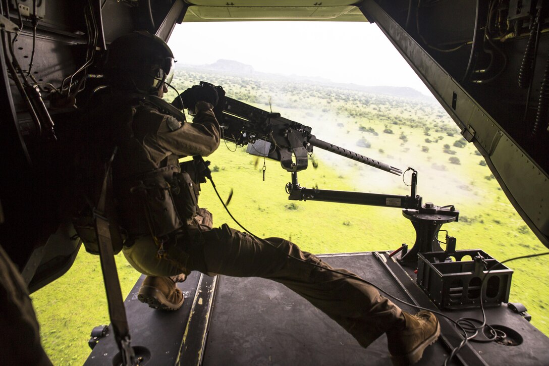 A U.S. Marine with Special-Purpose Marine Air-Ground Task Force Crisis Response-Africa shoots out the back of an MV-22B Osprey at a range outside Accra, Ghana, April 13, 2015. The aircrew completed the range to maintain their weapon proficiency while flying. (U.S. Marine Corps photo by Sgt. Paul Peterson/Released)