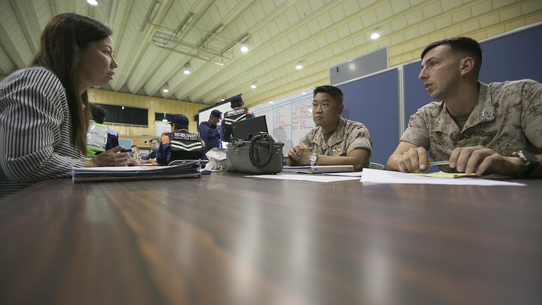 Maj. Thai N. Nguyen, G-5, planner, MCIPAC and Capt. Benjamin J. Carlton, a pilot with Marine Light Attack Helicopter Squadron 269, 1st Marine Aircraft Wing, III Marine Expeditionary Force, team up with a Japanese liaison to coordinate a CH-53E Super Stallion landing July 23, during the Churashima Rescue Exercise on Camp Naha, Okinawa, Japan. According to Nguyen, the Marine Corps saw this as an excellent opportunity to build cohesion among the two forces. “U.S. and Japanese forces have a long history of working together, and we value every opportunity to learn from one another and to maintain the readiness of our militaries,” said Nguyen. “Marine forces will continue to train bilaterally with JGSDF and multilaterally with U.S. allies throughout the Asia-Pacific to enhance regional stability.”