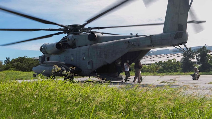 Marines with Marine Corps Installations Pacific and Marine Heavy Helicopter Squadron 462, 1st Marine Aircraft Wing, 3rd Marine Expeditionary Force assist role players off a CH-53E Super Stallion July 23, during the Churashima Rescue Exercise on Camp Naha, Okinawa, Japan. The event marked the first year Marines participated in the exercise, supporting mutual preparation and demonstrating the importance of interoperability. “(The exercise) is exactly the type of mission that requires JSDF and the Marine Corps cooperation and coordination,” said Maj. Thai N. Nguyen, G-5, planner, MCIPAC. “When (this is) accomplished in advance of a disaster, (it) saves valuable time, resources, and lives.”