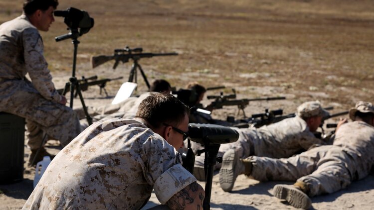 Marines with 1st Reconnaissance Battalion, 1st Marine Division, 1st Marine Expeditionary Force, conduct unknown distance shooting while their instructors watch during the Pre-Scout Sniper Course at Marine Corps Base Camp Pendleton, California, July 17, 2015. The six-week long course is designed to prepare and screen students for the follow-on training at Scout Sniper Basic School.