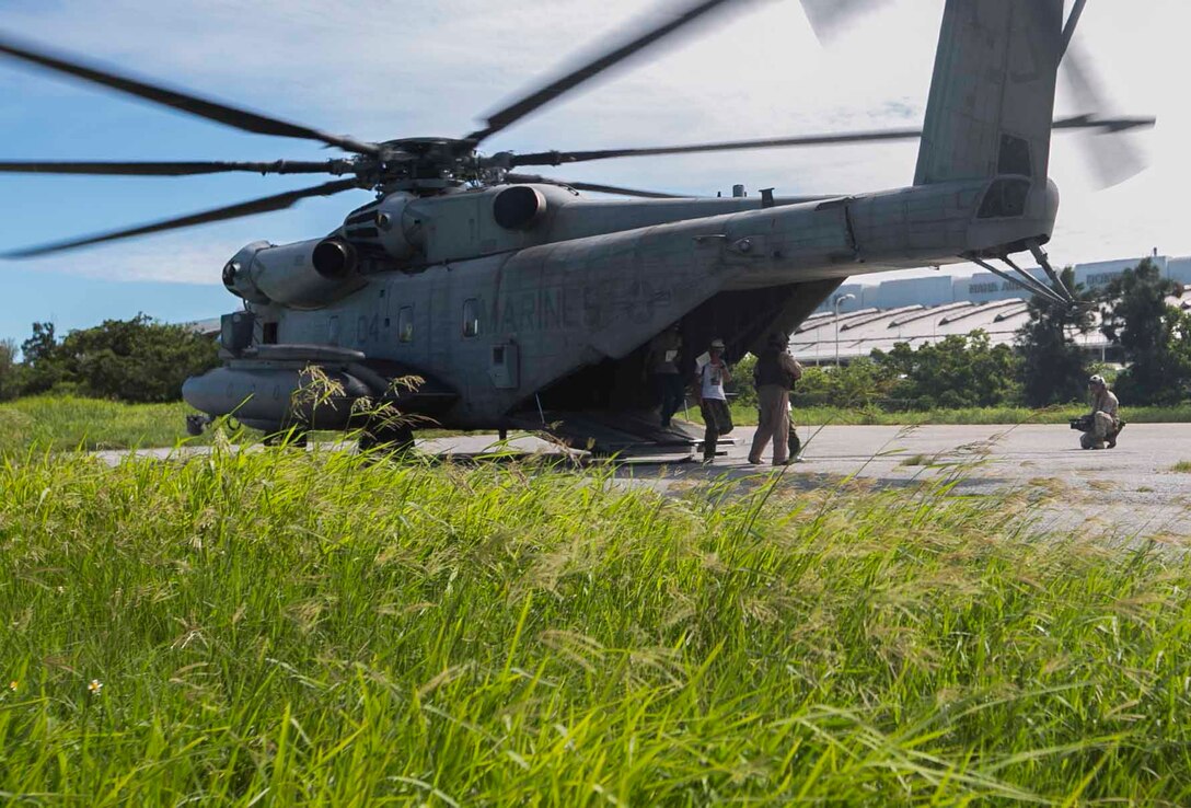 Marines with Marine Corps Installations Pacific and Marine Heavy Helicopter Squadron 462, 1st Marine Aircraft Wing, 3rd Marine Expeditionary Force assist role players off a CH-53E Super Stallion July 23, during the Churashima Rescue Exercise on Camp Naha, Okinawa, Japan. The event marked the first year Marines participated in the exercise, supporting mutual preparation and demonstrating the importance of interoperability. “(The exercise) is exactly the type of mission that requires JSDF and the Marine Corps cooperation and coordination,” said Maj. Thai N. Nguyen, G-5, planner, MCIPAC. “When (this is) accomplished in advance of a disaster, (it) saves valuable time, resources, and lives.” (U.S. Marine Corps photo by Lance Cpl. Daniel Jean-Paul/Released)