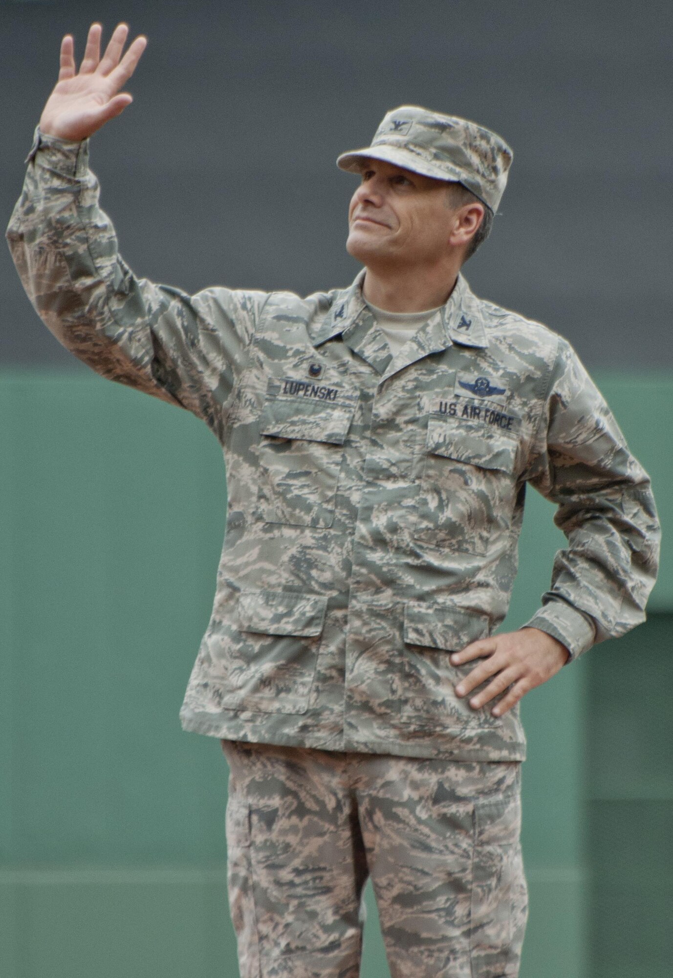 Colonel Albert Lupenski, Commander of the 439th Airlift Wing at Westover Air Reserve Base, Mass. waves to thousands of cheering baseball fans before throwing out the first pitch of a Red Sox game on Military Appreciation Day held on July 4, 2015 at Fenway Stadium, Boston. 