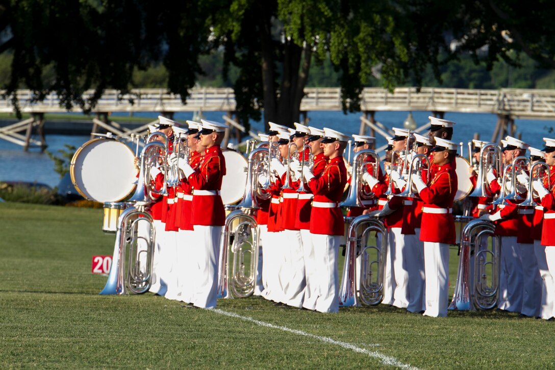The United States Marine Drum and Bugle Corps perform during a Battle Color Detachment show at the U.S. Naval Academy, July 23, 2015. The Battle Color Ceremony features the U.S. Marine Drum & Bugle Corps, the Silent Drill Platoon and the Marine Corps Color Guard. All are attached to Marine Barracks Washington, D.C. These Marines appear in hundreds of ceremonies annually across the country and abroad.(U.S. Marine Corps photo by Cpl. Skye A. Davis/Released)
