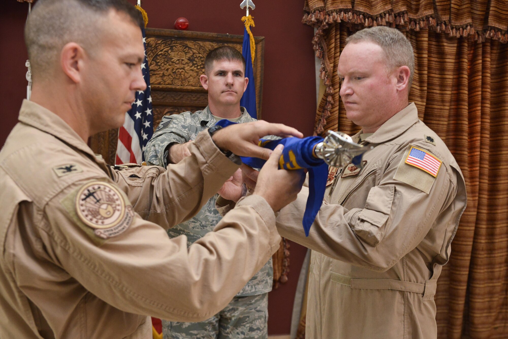 Col. James Dittus, 379th Expeditionary Operations Group commander and Lt. Col Ronald Schochenmaier, 22d Expeditionary Air Refueling Squadron commander, unveil the squadron flag during an assumption of command ceremony for the 22d EARS July 24th 2015 at Al Udeid Air Base, Qatar. The 22d was first formed in 1939 primarily as a bomb squadron for World War II. In 2002 it was inactivated as the 22d Air Refueling Squadron and is now re-designated as the 22d EARS supporting operations from Al Udeid Air Base. (U.S. Air Force photo/Staff Sgt. Alexandre Montes)