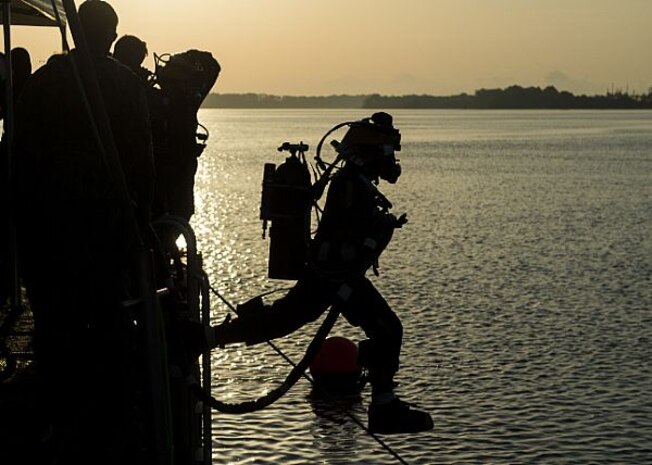 150713-N-XJ695-038 SAVANNAH, Ga. (July 13, 2015) An Explosive Ordnance Disposal Technician plunges into the waters of the Savannah River in support of the salvage of Civil War ironclad CSS Georgia. Navy Divers from Mobile Diving and Salvage Unit 2 (MDSU2) and Explosive Ordnance Disposal Technicians from Explosive Ordnance Disposal Mobile Unit (EODMU) 6 are working in conjunction with archaeologists, conservationists, Naval History and Heritage Command, and the US Army Corps of Engineers in a project directed by Naval Sea Systems Command (NAVSEA) Supervisor of Salvage and Diving (SUPSALV) to salvage and preserve CSS Georgia. (U.S. Navy photo by Mass Communication Specialist 2nd Class Jesse A. Hyatt/Released)