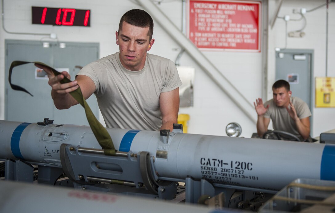 Staff Sgt. Mario Alba, 33rd Aircraft Maintenance Squadron load crew chief, prepares to load an AIM-120 Advanced Medium-Range Air-to-Air Missile to an F-35A Lightning II during a weapons load competition on Eglin Air Force Base, Fla., July 10, 2015. The competition was the first time teams faced off in a shotgun start event to load munitions on side-by-side F-35A Lightning IIs. (U.S. Air Force Photo/Staff Sgt. Marleah Robertson)