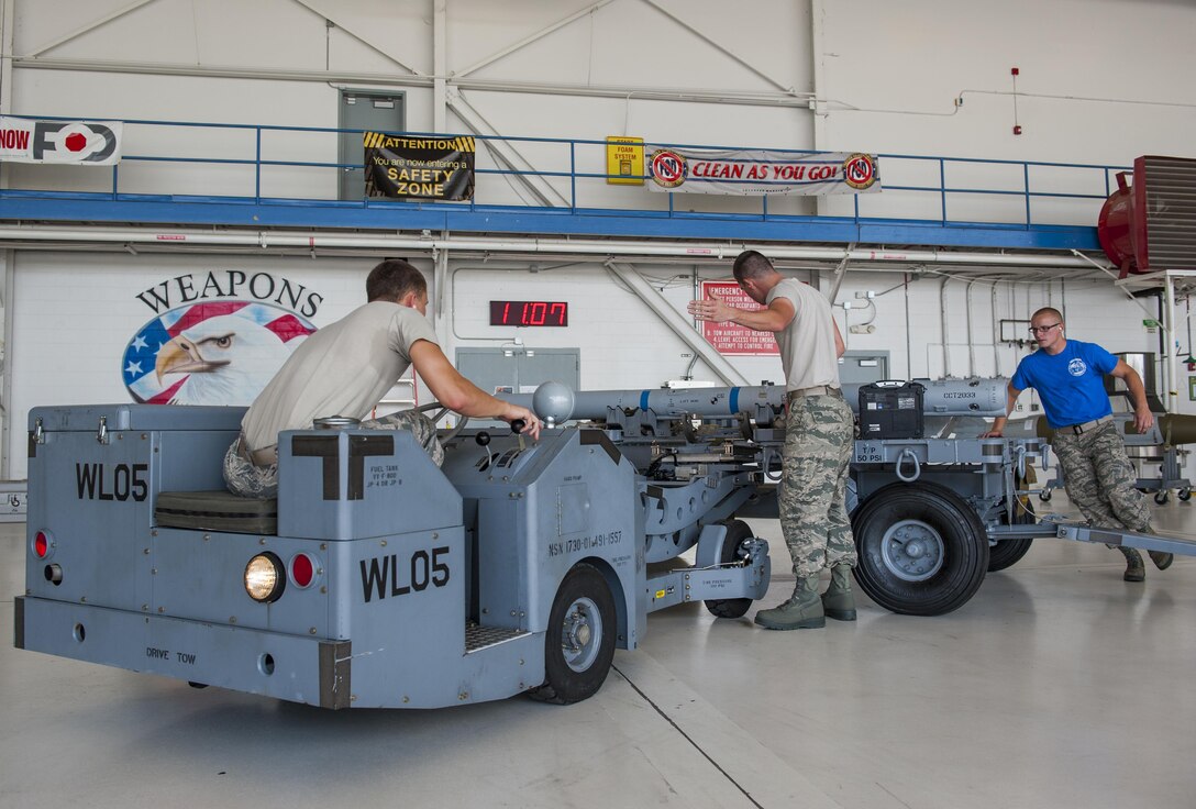 Airmen with the 33rd Aircraft Maintenance Squadron compete in a weapons load competition on Eglin Air Force Base, Fla., July 10, 2015. During weapons load competitions, crews are evaluated on a uniform inspection, a written test, a quality assurance inspection of the teams’ tool kits and how safely, efficiently and timely they load munitions on an F-35A. (U.S. Air Force Photo/Staff Sgt. Marleah Robertson)