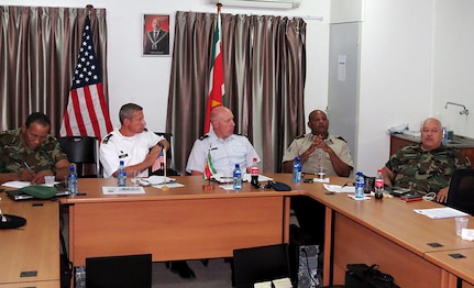 U.S. Army Lt. Col. Orson Ward, second from left, South Dakota Army National Guard, and U.S. Air Force Maj. Kevin Miller, center, South Dakota Air National Guard, participate in a subject matter expert exchange on strategic planning in Paramaribo, Suriname, July 15, 2015. 