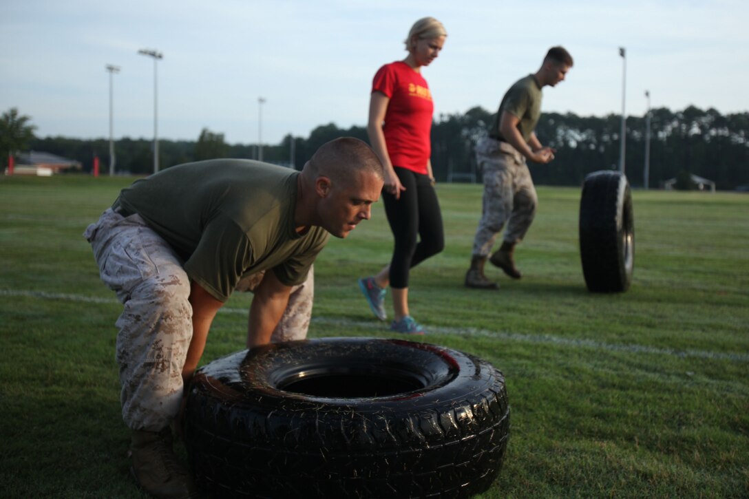 Gunnery Sgt. Eric Ammon, a Harrier engine mechanic instructor with the Center for Naval Aviation Technical Training, flips a tire in a strength and endurance testing event during the High Intensity Tactical Training program’s inaugural preliminary Tactical Athlete Competition at Marine Corps Air Station Cherry Point, North Carolina, July 22, 2015. The top male and female winners are scheduled to compete in the final event being held at Marine Corps Air Ground Combat Center, Twentynine Palms, California, on September 16 to compete for the Ultimate Tactical Athlete in the Marine Corps.