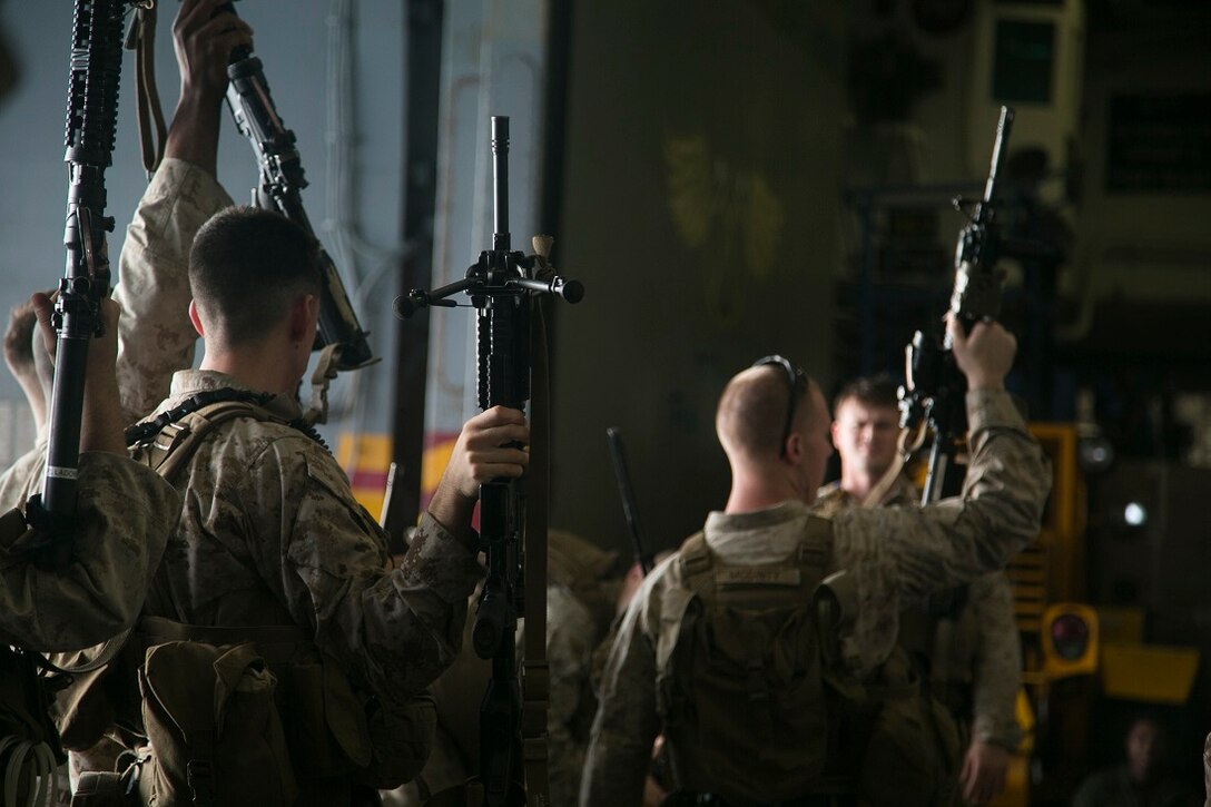 INDIAN OCEAN (July 21, 2015) U.S. Marines with Lima Company, Battalion Landing Team 3rd Battalion, 1st Marine Regiment, 15th Marine Expeditionary Unit (MEU), take accountability for their M16 service rifles during a quick reaction force rehearsal aboard the amphibious assault ship USS Essex (LHD 2). Elements of the 15th MEU, based out of Camp Pendleton, California, and embarked aboard the Essex, are conducting naval operations in the 6th Fleet area of operations in support of U.S. national security interests in Europe and Africa. (U.S. Marine Corps photo by Cpl. Anna Albrecht/Released)