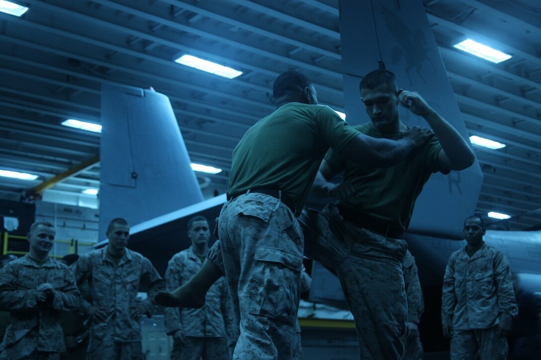 INDIAN OCEAN (July 22, 2015) U.S. Marine Sgt. Charles A. Brown, left, demonstrates a counter to a round-house kick from Cpl. Martin Corona during a Marine Corps Martial Arts Program (MCMAP) course aboard the amphibious assault ship USS Essex (LHD 2). Brown and Corona are MCMAP instructors both with the “Greyhawks” of Marine Medium Tiltrotor Squadron 161 (Reinforced), 15th Marine Expeditionary Unit. These instructors were teaching techniques for a course of Marines trying to earn their brown or black belt.  Elements of the 15th MEU, based out of Camp Pendleton, California, and embarked aboard the Essex, are conducting naval operations in the 6th Fleet area of operations in support of U.S. national security interests in Europe and Africa. (U.S. Marine Corps photo by Staff Sgt. Miguel Carrasco/Released)