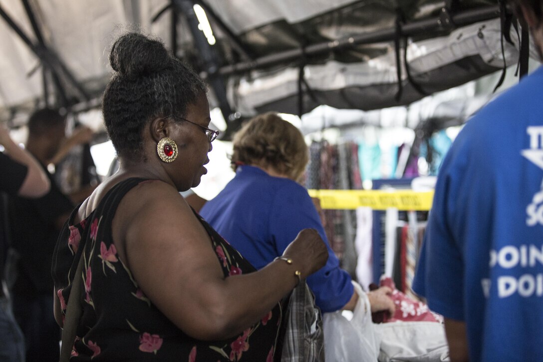 A veteran selects clothes at a service tent during the San Diego Stand Down for Homeless Veterans and their families, July 18. Marine Wing Support Squadron 373 from Marine Corps Air Station Miramar transported, set-up and maintained the tents and other equipment used during the stand down. (U.S. Marine Corps photo by Sgt. Lillian Stephens)