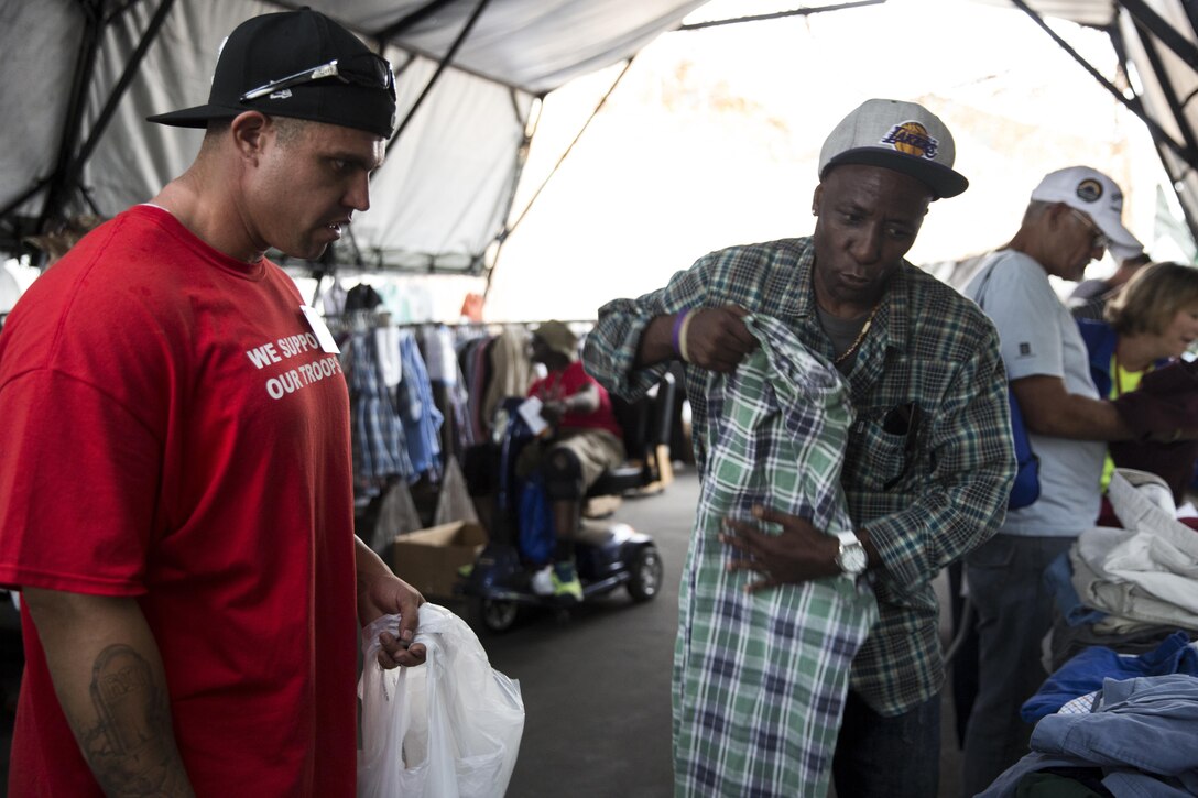 Charles Johnson, Navy Veteran and a Chicago, Illinois native, selects clothes during the San Diego Stand Down for Homeless Veterans and their families of San Diego, July 18. Marine Wing Support Squadron 373 from Marine Corps Air Station Miramar transported, set-up and maintained the tents and other equipment used during the stand down. (U.S. Marine Corps photo by Sgt. Lillian Stephens)