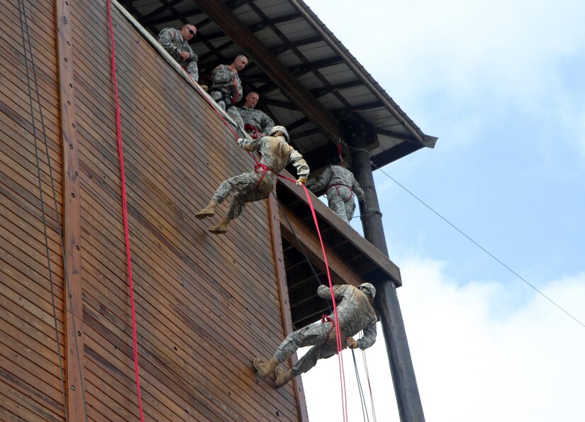 Cadets of the 7th Regiment, Combat Leader Course negotiate the rapelling tower Saturday, July 11 at Fort Knox, Ky. The rappelling tower exercise is used to help cadets overcome fear, instill them with confidence and to build empathy for their subordinates in challenging circumstances. (U.S. Army Photo by Sgt. Javier Amador)