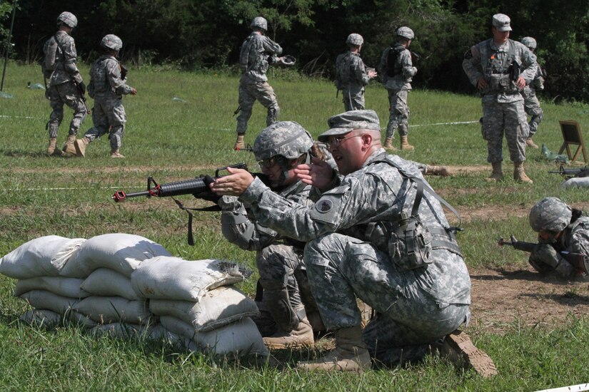 Sgt. 1st Class Aaron L. Masters, an instructor with B Company, 1st Battalion, 334th Regiment, 104th Training Division (LT) shows a cadet with the 7th Regiment Cadet Initial Entry Training (CIET) how to maintain a target in her M16 rifle's sights in order to provide effective cover fire while on the Individual Movement Techniques (IMTs) training lane at the Christensen Hand Grenade Assault Course on Wednesday, July 16 at Fort Knox, Ky. IMTs allow Soldiers to move tactically in teams from point to point while providing cover fire for each other. (U.S. Army Photo by Sgt. Javier Amador)