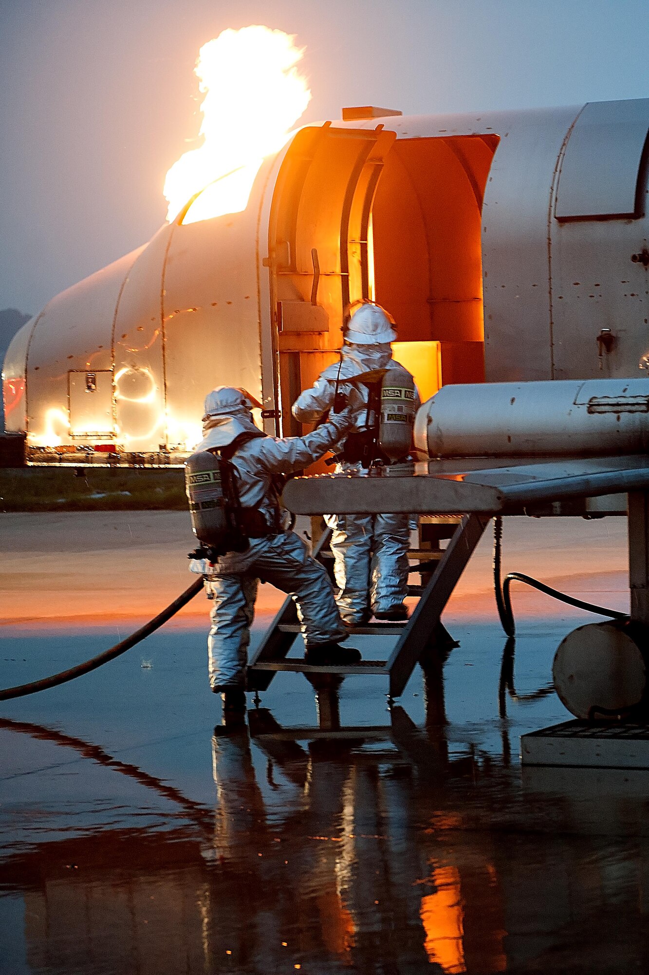 U.S. Air Force Airmen from the 8th Civil Engineer Squadron fire department extinguish a simulated aircraft fire during Exercise Beverly Midnight 15-4, July 14, 2015, at Kunsan Air Base, Republic of Korea. The simulated aircraft crash provided additional training for the fire fighters and tested emergency responder’s ability to respond to wartime scenarios. (U.S. Air Force photo by Senior Airman Divine Cox/Released)