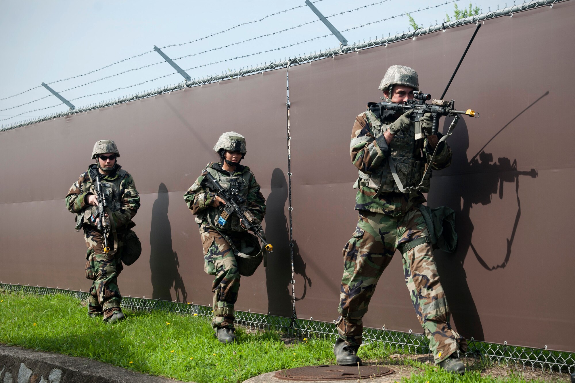 U.S. Air Force Airmen from the 8th Security Forces Squadron conduct perimeter security following a simulated ground attack during Exercise Beverly Midnight 15-4 at Kunsan Air Base, Republic of Korea, July 16, 2015. Combat Airmen reacted, survived and operated in a simulated combat zone to validate and enhance Kunsan’s mission to defend the base and take the fight north during the five-day operational readiness exercise. (U.S. Air Force photo by Senior Airman Katrina Heikkinen/Released)