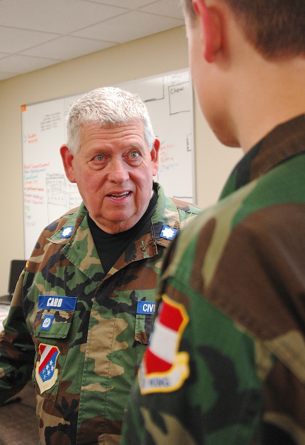 Lt. Col. James Card, (center), assistant director of communications and licensing officer, Georgia Wing Civil Air Patrol, discusses the CAP's three missions with a young cadet during Georgia Wing CAP’s weeklong summer encampment at Marine Corps Logistics Base Albany, July 21-25.