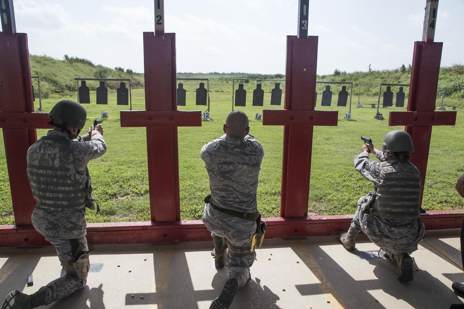 Weapons qualification course students fire their Beretta M9 pistols during the range portion of their training July 6 at the Joint Base San Antonio-Lackland Medina Annex. During this portion, students practice both kneeling and standing firing positions and record the accuracy of their hits with combat arms instructors to verify their weapon competency. The weapons qualification course is part of the Combat Arms Training and Maintenance program that introduces basic firearm safety and use practices for Airmen in Air Force Basic Military Training and refreshes that training for JBSA members deploying or undergoing a permanent change of station. 