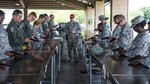 Staff Sgt. James Robinette, 37th Training Squadron combat arms instructor, gives directions on how to ensure the weapon is clean after use during the cleaning and maintenance portion of a weapons qualification course July 6 at the Joint Base San Antonio-Lackland Medina Annex. The weapons qualification course is part of the Combat Arms Training and Maintenance program that introduces basic firearm safety and use practices for Airmen in Air Force Basic Military Training and refreshes that training for JBSA members deploying or undergoing a permanent change of station. 