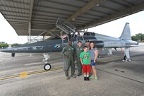 Lt. Col. Ryan Sparkman, 560th Flying Training Squadron assistant director of operations, stands with Jared Stadler, 560th FTS pilot for a day, and the Stadler family in front of a T-38 Talon July 17, 2015, at Joint Base San Antonio-Randolph. Since 1994, squadron members have sponsored the “Pilot for A Day” program for children of all ages with chronic illnesses.   The goal of the program is to give these children a break from the challenges they face each day because of their illnesses.
