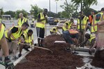 Members of the 902 nd Security Forces Squadron and the Air Force Recruiting School spread mulch July 18, 2015, at the Joint Base San Antonio-Randolph base exchange parking lot. The event was part of a base clean up effort to prepare JBSA-Randolph for the upcoming Air Education and Training Command change of command July 21, 2015.