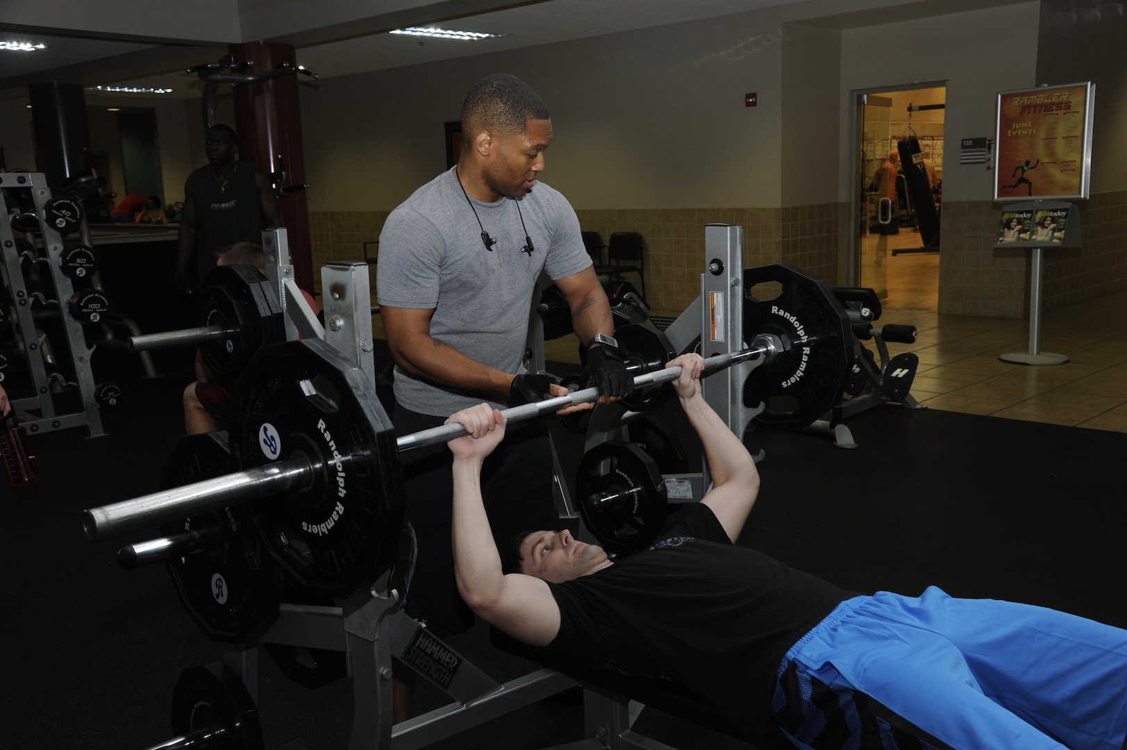 Tech. Sgt. Damien Mount (standing), 502nd Communications Squadron client service supervisor, and Senior Airman Matthew Whitton, 502nd CS client systems technician, work out on the bench presses June 23 at the Joint Base San Antonio-Randolph Rambler Fitness Center.