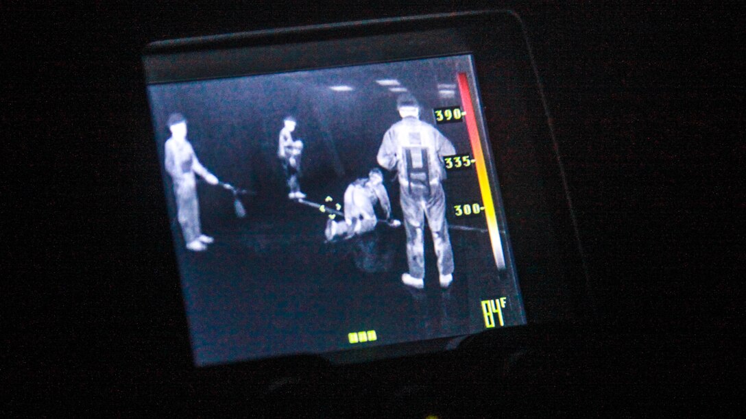 Marines from the Search and Extraction Platoon, Chemical Biological Incident Response Force, use a thermal imaging camera to help conduct a search in a room with no light during Exercise Scarlet Response 2015 at Guardian Centers in Perry, Georgia, July 21, 2015. The Search and Extraction Platoon is the second team to go into a building after the primary assessment team, who gather the first wave of intelligence that will be used to define the manner in which the mission will be accomplished They search and extract victims that can’t move or are seriously injured.