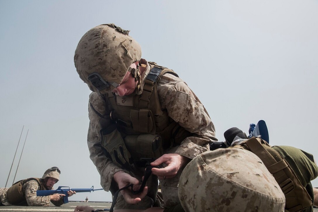 ARABIAN GULF (July 20, 2015) U.S. Marine Cpl. Drake Hayes treats a simulated casualty while rehearsing combat lifesaving skills during a mass casualty response exercise aboard the dock landing ship USS Rushmore (LSD 47). Hayes is a military policeman with Combat Logistics Battalion 15, 15th Marine Expeditionary Unit. Marines with CLB-15 rehearsed responding to enemy contact, treating simulated casualties, and calling in medical evacuations. The Marines of the CLB-15 are the logistics combat element of the 15th MEU which is embarked on the Essex Amphibious Ready Group and is deployed to maintain regional security in the U.S. 5th Fleet area of operations.  (U.S. Marine Corps photo by Sgt. Emmanuel Ramos/Released)