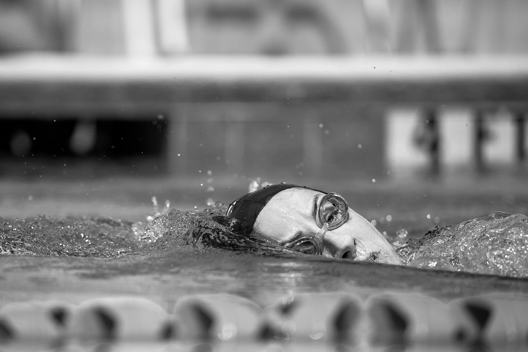 U.S. Air Force 1st Lt. Morgan K. Diglia, Sexual Assault Response Coordinator deputy, surfaces for air while swimming at the McGarr Pool on Goodfellow Air Force Base, Texas, July 24, 2015. Diglia is prepping for an olympic triathlon, which includes a 1.5km swim, 40km bike ride, and a 10km run. (U.S. Air Force photo by Staff Sgt. Michael Smith/Released)