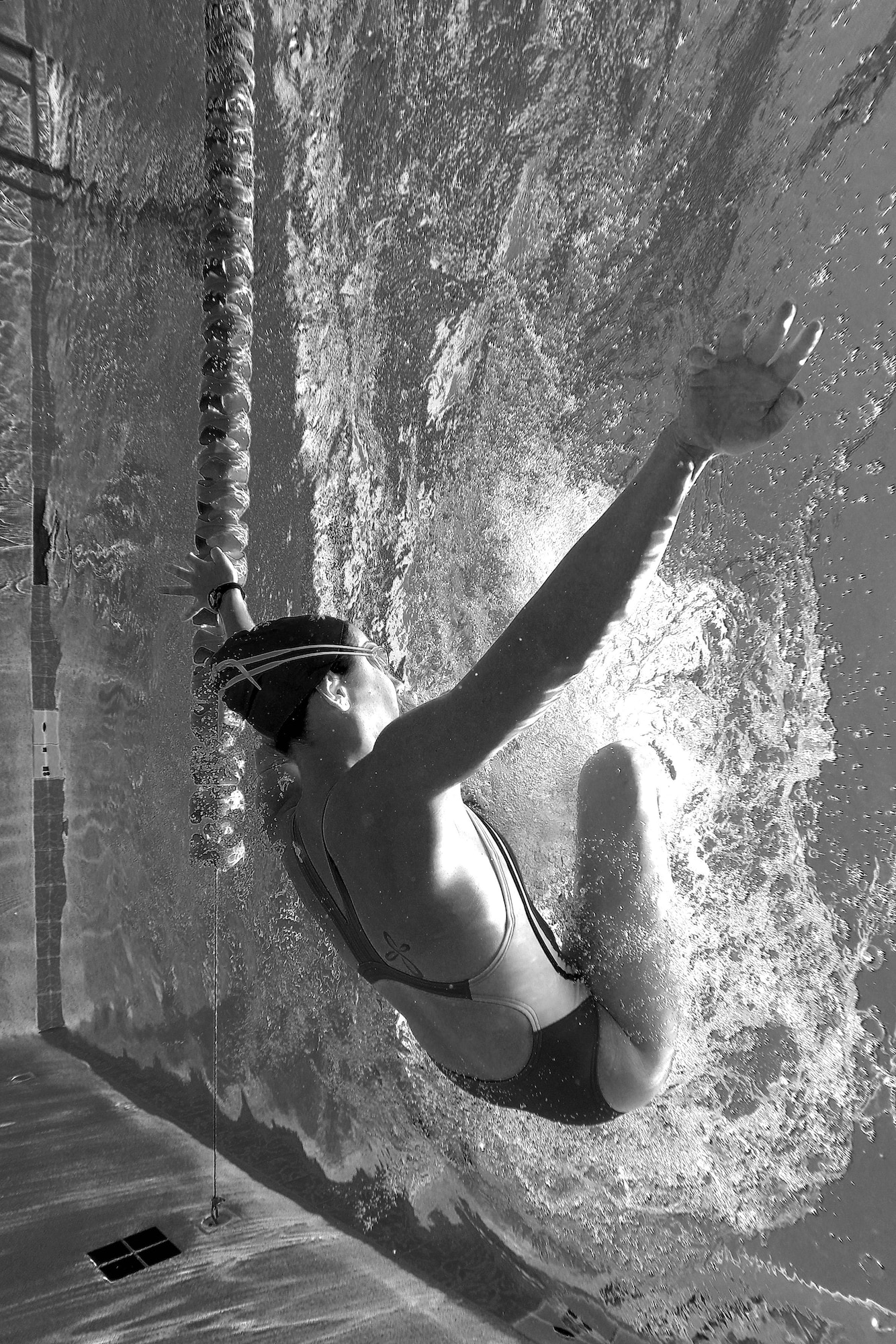 U.S. Air Force 1st Lt. Morgan K. Diglia, Sexual Assault Response Coordinator deputy, performs a flip-turn while swimming at the McGarr Pool on Goodfellow Air Force Base, Texas, July 24, 2015. Diglia is preparing for an upcoming olympic triathlon. (U.S. Air Force photo by Staff Sgt. Michael Smith/Released)