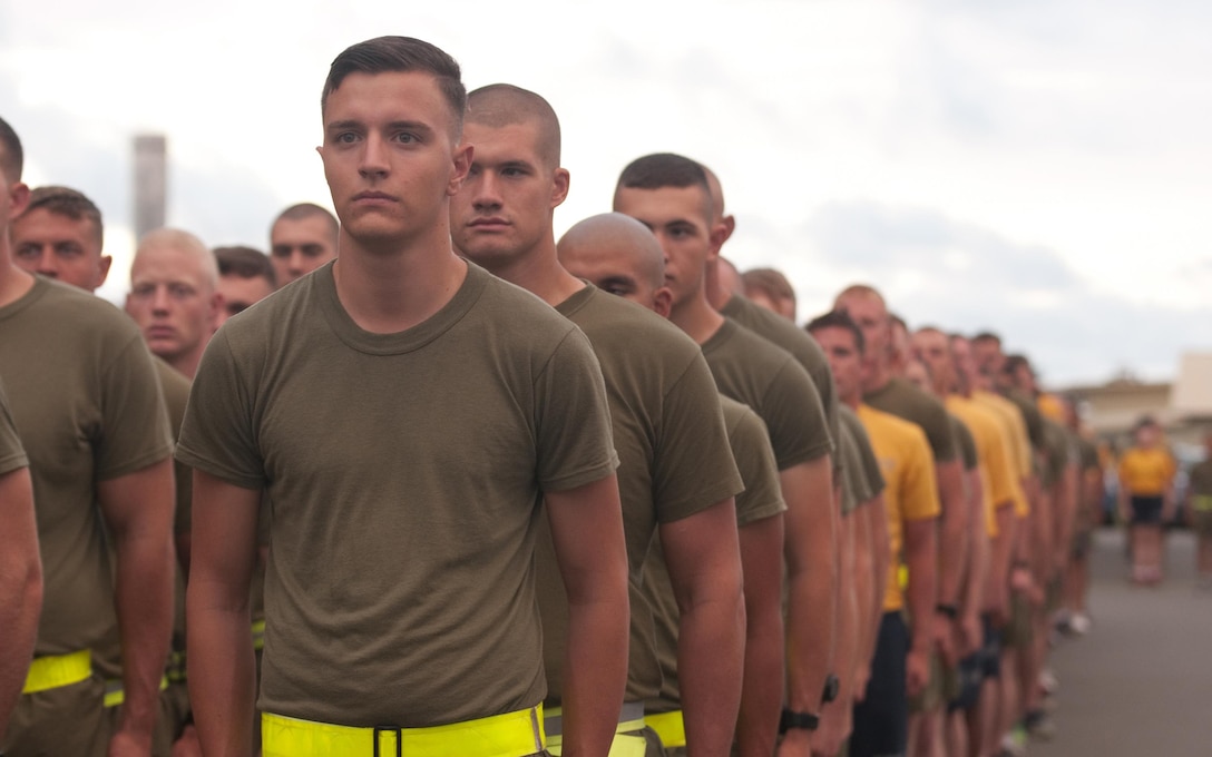 The Marines and Sailors of Marine Aviation Logistics Squadron 24, execute an about face, preparing to begin a squadron run from Hangar 375, July 22, 2015. The “Warriors” conducted morning physical training with a formation run, calling cadence. (U.S. Marine Corps photo by Kristen Wong/Released)