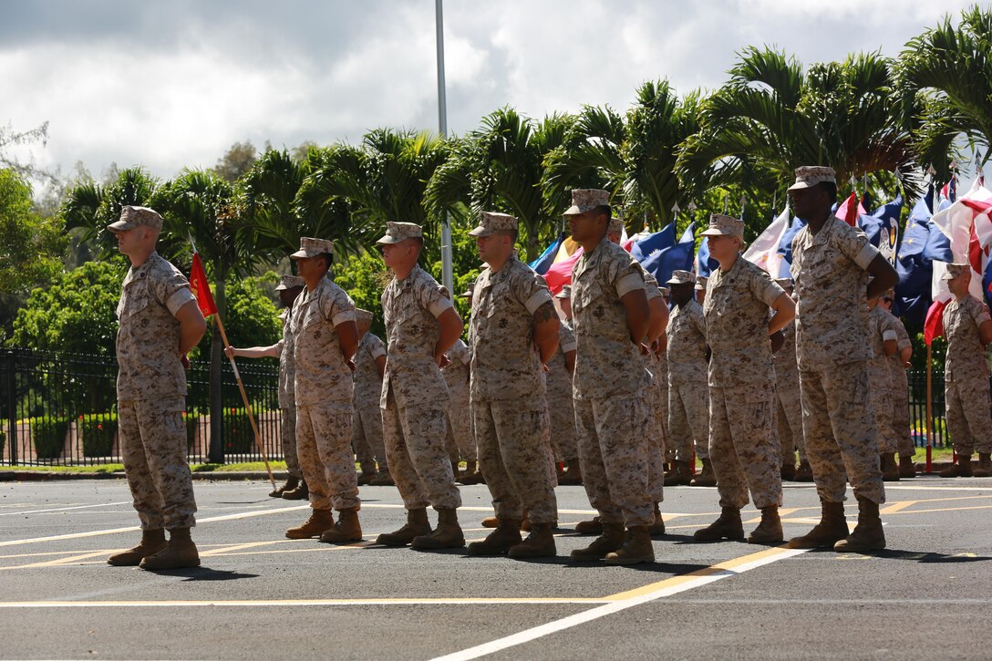 The U.S. Marine Corps Forces, Pacific color guard presents arms during the relief and appointment ceremony on Camp H. M. Smith, Hawaii, July 23, 2015. During the ceremony, Sgt. Maj. William T. Stables relinquished his duties as MARFORPAC sergeant major to Sgt. Maj. Paul G. McKenna.