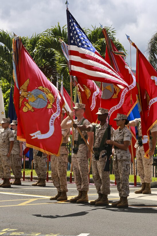 The U.S. Marine Corps Forces, Pacific color guard presents arms during the relief and appointment ceremony on Camp H. M. Smith, Hawaii, July 23, 2015. During the ceremony, Sgt. Maj. William T. Stables relinquished his duties as MARFORPAC sergeant major to Sgt. Maj. Paul G. McKenna.