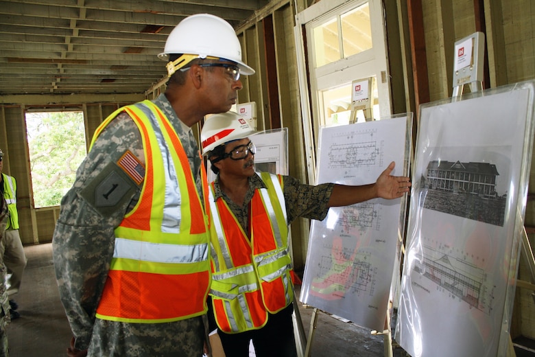 FORT SHAFTER, Hawaii (July 24, 2015) --  U.S. Army Pacific Commander Gen. Vincent K. Brooks looks at an historic photo of Fort Shafter's Bldg. T-112 taken circa. 1910 during a briefing about the building's rehabilitation project from Honolulu District Supervisory Engineer Steve Yamamoto. Building T-112, built in 1907 and also known as Dunning Hall, is an important structure that is a key part of the Palm Circle National Historic Landmark District. 