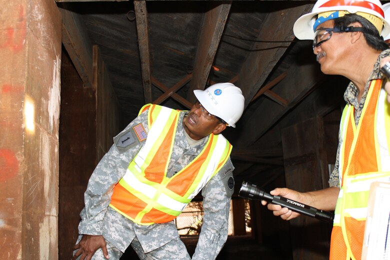 FORT SHAFTER, Hawaii (July 24, 2015) --  Honolulu District Supervisory Engineer Steve Yamamoto shows U.S. Army Pacific Commander Gen. Vincent K. Brooks World War II graffiti painted on a pillar in the basement of Fort Shafter's Bldg. T-112 . Building T-112, built in 1907 and also known as Dunning Hall, is an important structure that is a key part of the Palm Circle National Historic Landmark District. 