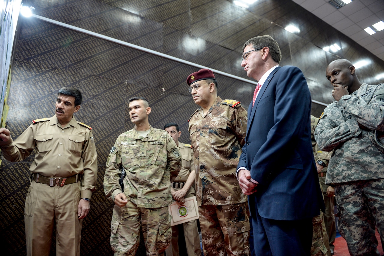 Defense Secretary Ash Carter and Gen. Taleb Shegati al-Kenani, commander of Iraq's counterterrorism forces, center, look over a map at the Combined Joint Operations Center in Baghdad, July 23, 2015. Carter is on a weeklong trip to the Middle East. DoD photo by Army Sgt. 1st Class Clydell Kinchen