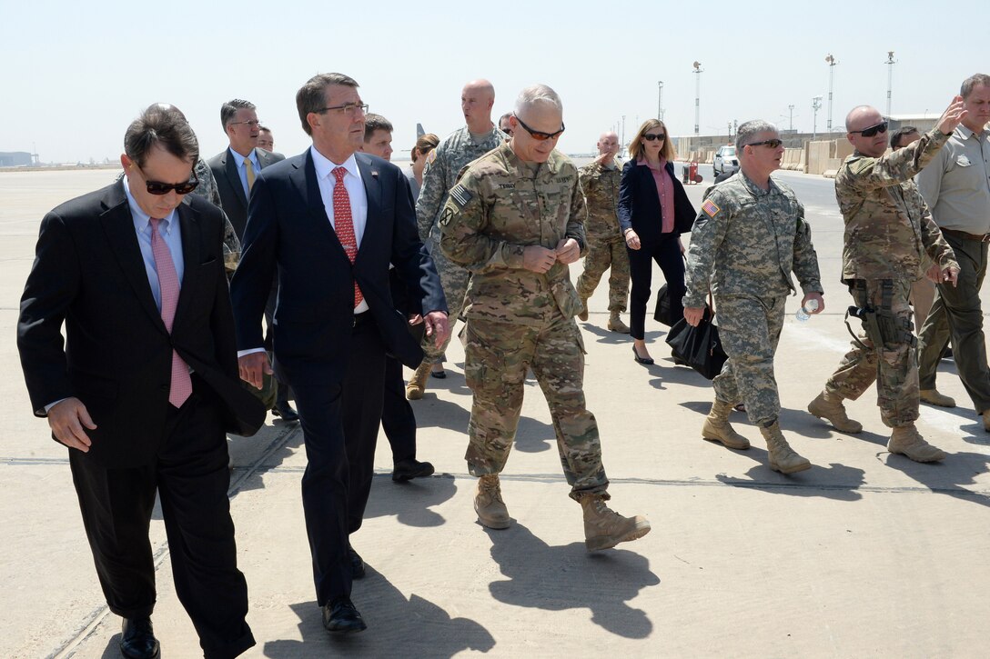 U.S. Defense Secretary Ash Carter, second from left, walks with U. S. Ambassador to Iraq Stuart E. Jones and U.S. Army Lt. Gen. James L. Terry after arriving in Baghdad, July 23, 2015.