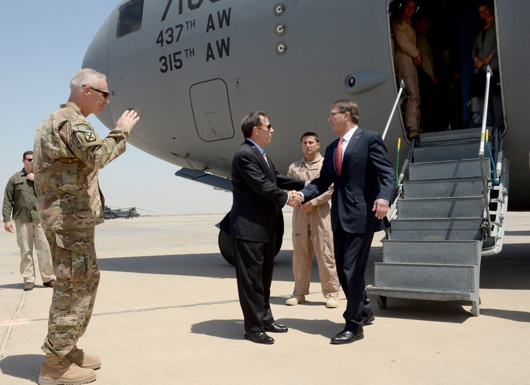 U.S. Defense Secretary Ash Carter, right, shakes hands with U.S. Ambassador to Iraq Stuart E. Jones as as he arrives in Baghdad, July 23, 2015. U.S. Army Lt. Gen. James L. Terry, left, also greeted Carter, who is on a weeklong trip to the Middle East that included stops in Israel, Jordan and Saudi Arabia.