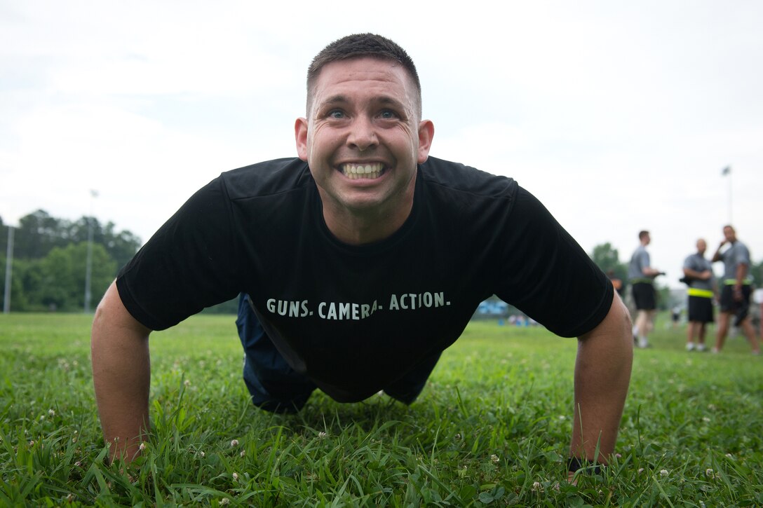Air Force Staff Sgt. Kenneth Norman participates in the push-up event during the 3rd annual U.S. Army Spc. Hilda I. Clayton Best Combat Camera competition on Fort Meade, Md., July 13, 2015. Norman is assigned to 1st Combat Camera Squadron.