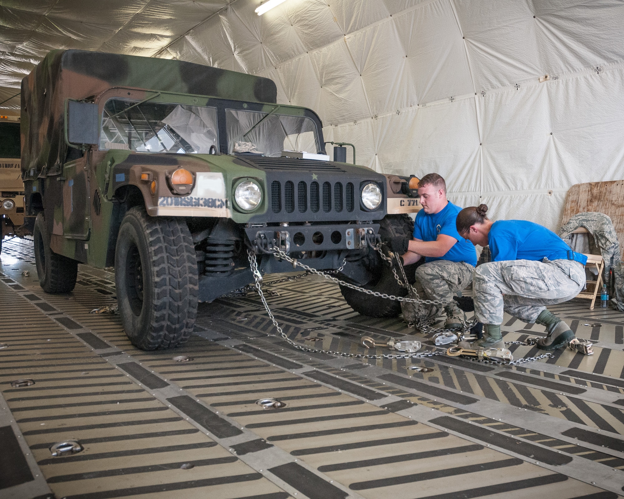 Senior Airmen Nick Graff and Tech. Sgt. Emily Erickson, 27th Aerial Port Squadron secure a humvee into the back of a C-5 aircraft as one of 12 challenges in the 2015 Port Dawg Challenge at Dobbins Air Reserve Base, GA.  The biennial competition tests Airmen and their abilities to execute aerial port operations in timed and scored events.  (U.S. Air Force photo by Staff Sgt. Stephanie Graybill/Released)