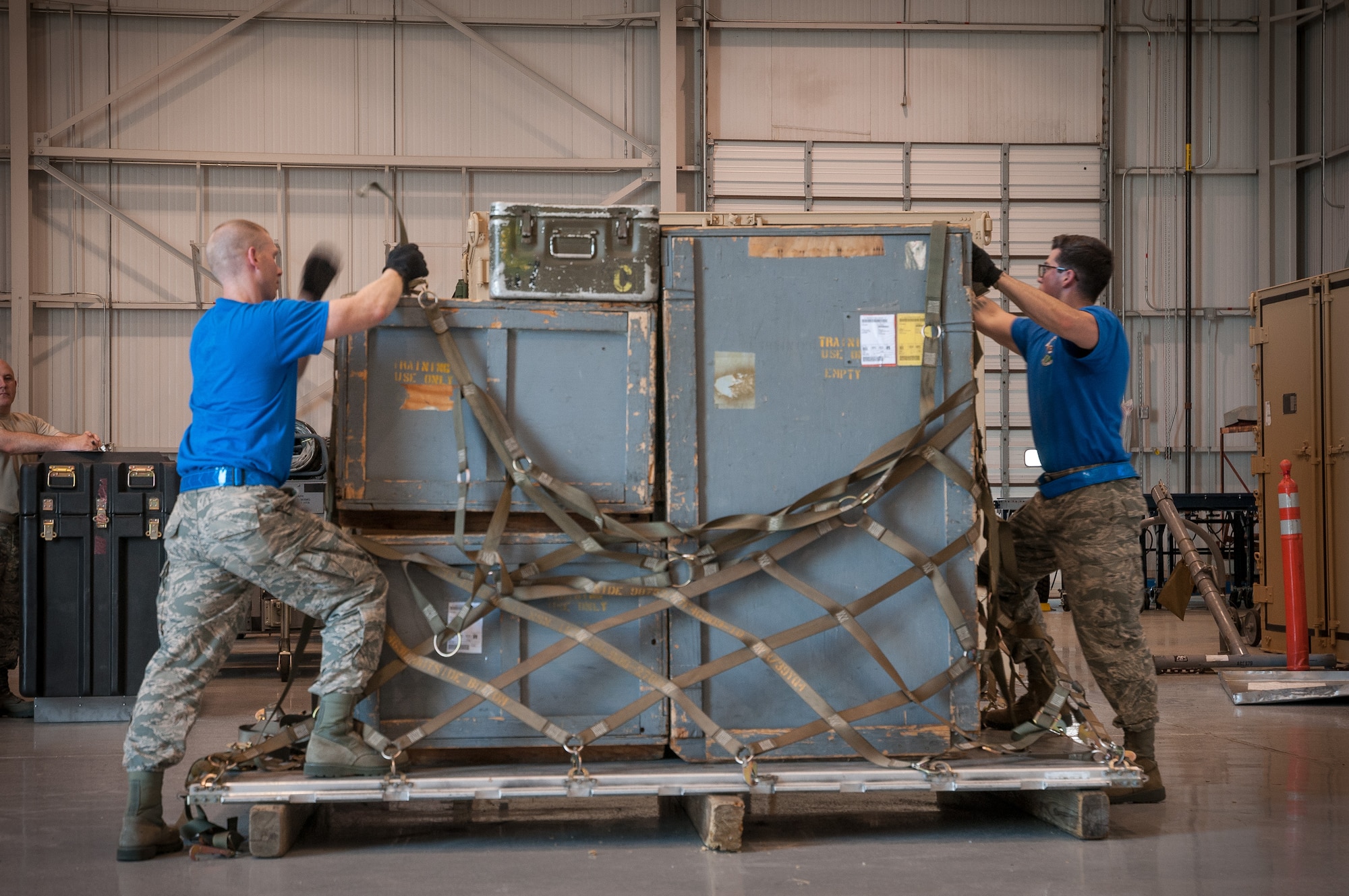 Tech. Sgt. Kyle Dagestad (left) and Senior Airmen Steven Nieminski, 27th Aerial Port Squadron Airmen, work quickly on a pallet buildup as one of 12 events during the 2015 Port Dawg Challenge at Dobbins Air Reserve Base, GA.   The biennial competition tests Airmen and their abilities to execute aerial port operations in timed and scored events.  (U.S. Air Force photo by Staff Sgt. Stephanie Graybill/Released)
