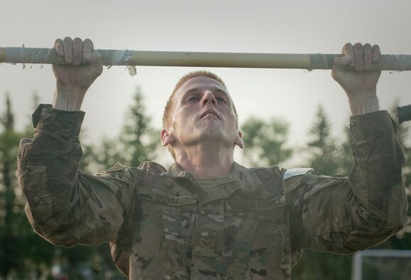 Senior Airman Aaron Royal, 5th Security Forces Squadron member, attempts to complete his final pull up during tryouts for his squadron’s Global Strike Challenge Competition team at Minot Air Force Base, N.D., July 23, 2015. The tryouts pushed Royal and other 5th SFS Airmen to their physical limits with a run in full gear, a gas mask run, pushups, pull ups, sit ups and other strength and endurance exercises. (U.S. Air Force photo/Senior Airman Stephanie Morris)