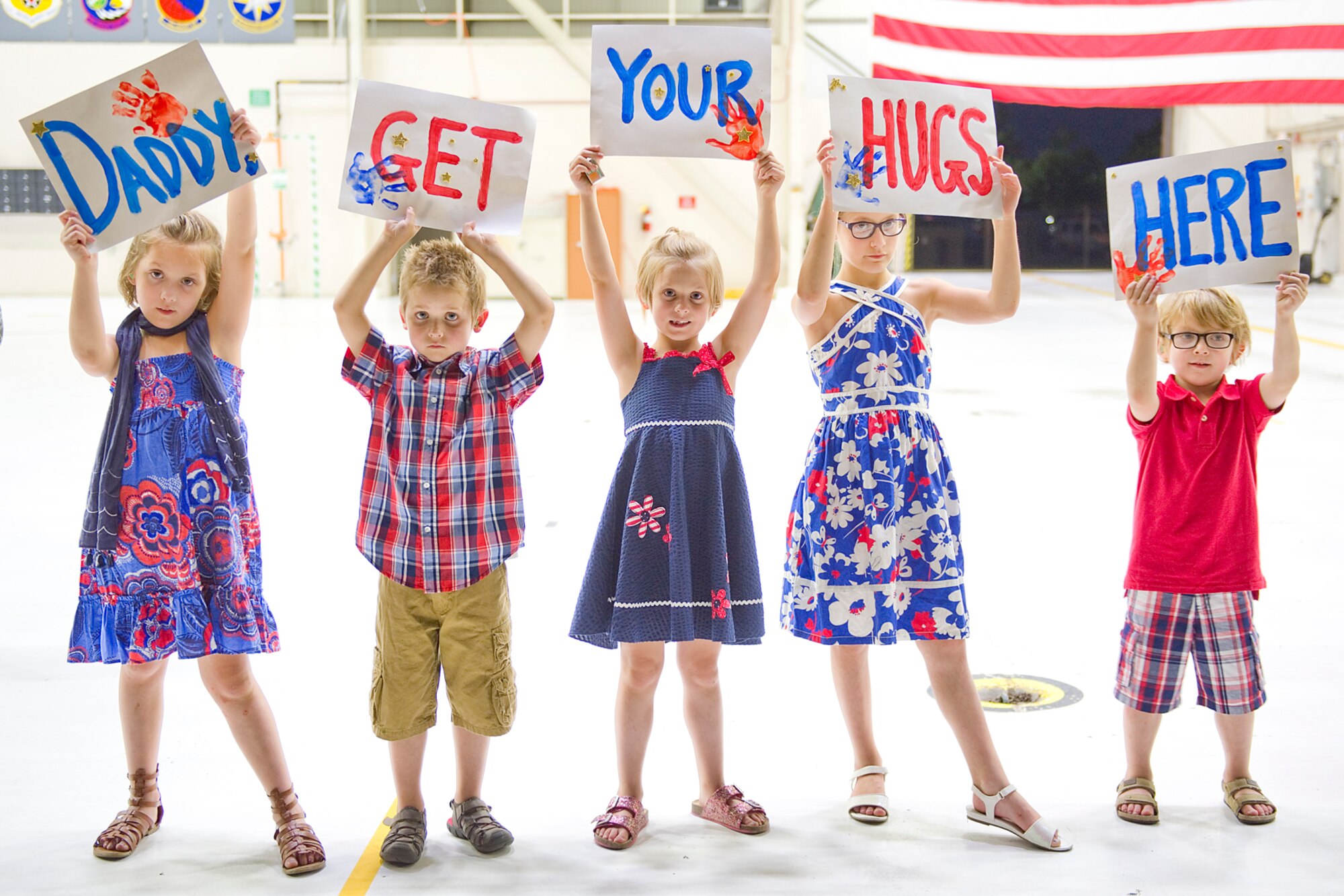 The family of Master Sgt. Robert T. Dill, III, 434th Civil Engineer Squadron power production journeyman, lines up to welcome him home to Grissom Air Reserve Base, Ind., July 22, 2015. Dill was among a group of 19 civil engineers who completed a 180-day deployment to Southwest Asia. (U.S. Air Force photo/Tech. Sgt. Benjamin Mota)