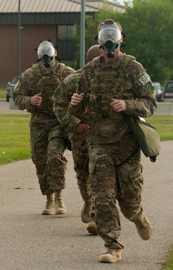 Members of the 5th Security Forces Squadron begin the gas mask run phase of tryouts for their squadron’s Global Strike Challenge Competition team at Minot Air Force Base, N.D., July 23, 2015. Airmen who completed all phases of the tryouts with the best times were selected to compete at the GSC in Guernsey, Wyo. (U.S. Air Force photo/Senior Airman Stephanie Morris)