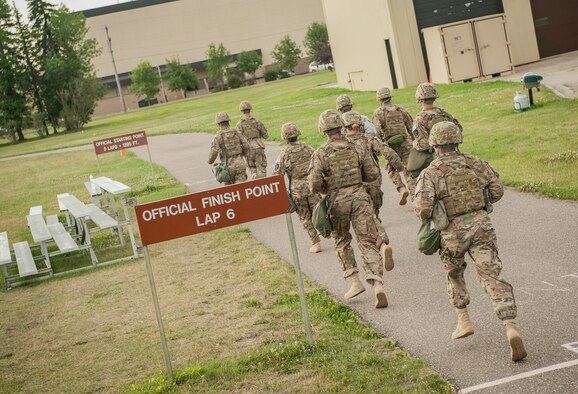 Members of the 5th Security Forces Squadron begin the first phase of tryouts for their squadron’s Global Strike Challenge Competition team at the McAdoo Sports and Fitness Center at Minot Air Force Base, N.D., July 23, 2015. The tryouts pushed the Airmen to their physical limits with a run in full gear, a gas mask run, pushups, pull ups, sit ups and other strength and endurance exercises.(U.S. Air Force photo/Senior Airman Stephanie Morris)