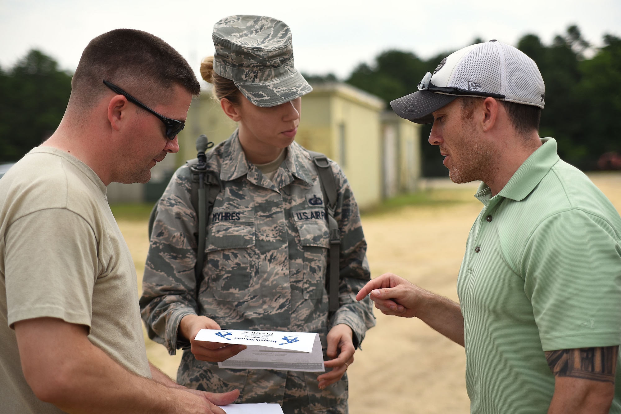 Master Sgt. Kevin Eberlin(right), executive assistant to the U.S. Air Force Expeditionary Center command chief and a role player in Turbo Distribution 15-7 as a host nation airfield manager, discusses an invoice for supplies with Technical Sgt. William Silvers(left) and Staff Sgt. Heather Myhres(center), both from the 821st Contingency Response Group during TD 15-7 at Joint Base McGuire-Dix-Lakehurst, New Jersey, July 21, 2015. Contingency Response units are able to survive and operate with their own equipment, but this tests their ability to also utilize equipment and supplies from the area they deploy to, which provides further sustainability for the units and possible follow-on forces. TD 15-7, a Joint Task Force-Port Opening (JTF-PO) field training exercise, hosted by the U.S. Air Force Expeditionary Center at Joint Base McGuire-Dix-Lakehurst, New Jersey, tests the ability to rapidly deploy and employ a JTF-PO Aerial Port of Debarkation (APOD) enabling capability in direct support to a regional combatant command.(U.S. Air Force photo/Danielle Brooks)
