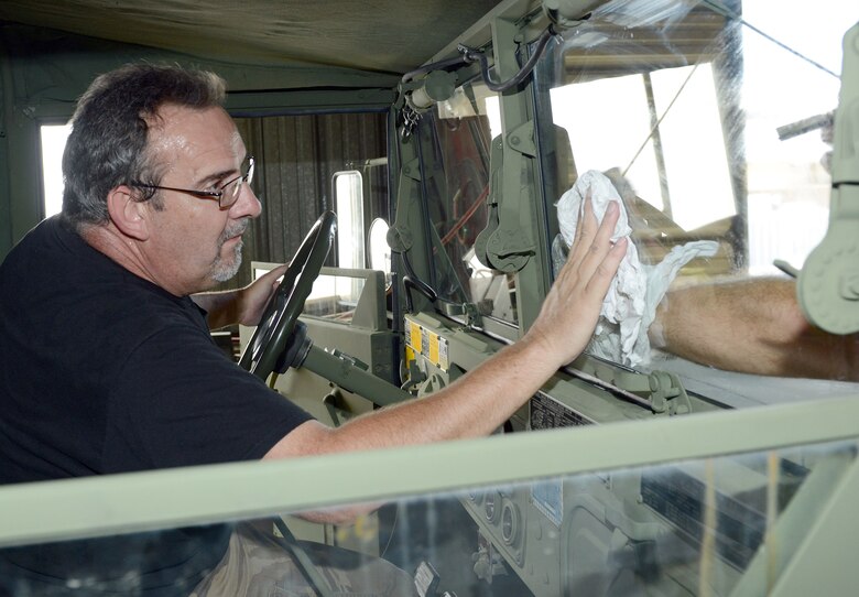 Gary Saylor, 78th Logistics Readiness Squadron vehicle mechanic, puts finishing touches on a newly-restored M-35 truck. The deuce and a half has been used since the Korean War to transport troops as well as cargo.  (U.S. Air Force photo by Tommie Horton)