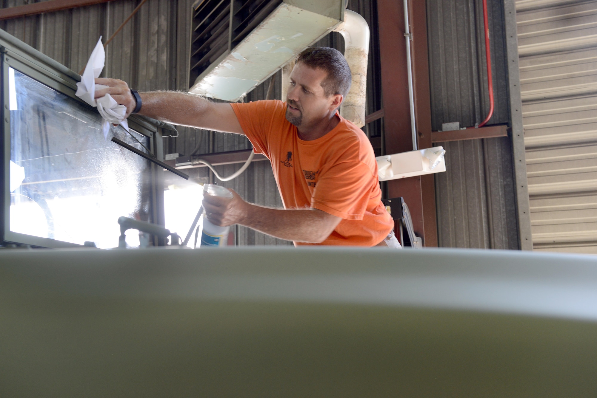 Henry Kirkpatrick, 78th Logistics Readiness Squadron vehicle mechanic, puts finishing touches on a newly-restored M-35 truck. The deuce and a half, as M-35s are commonly called, will be put on display at the Museum of Aviation. (U.S. Air Force photo by Tommie Horton)